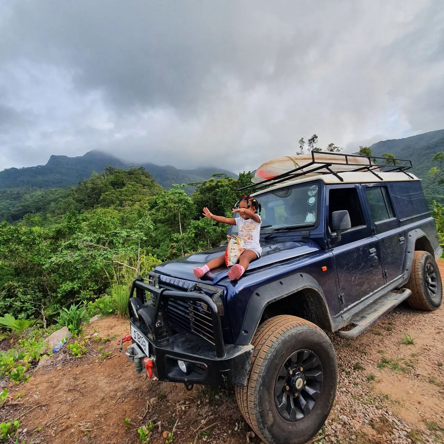 Defender on a mountain road above the coast, Mahé