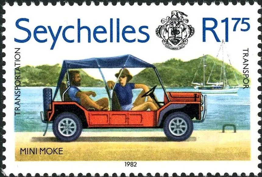 A Seychelles 1 rupee 75 postage stamp from 1982 showing a red Mini Moke with two passengers, captioned MINI MOKE