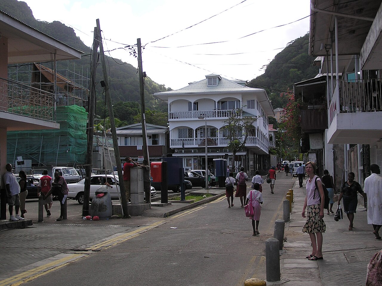 Market Street in Victoria, with shopfronts, a post box and the hills behind the town.