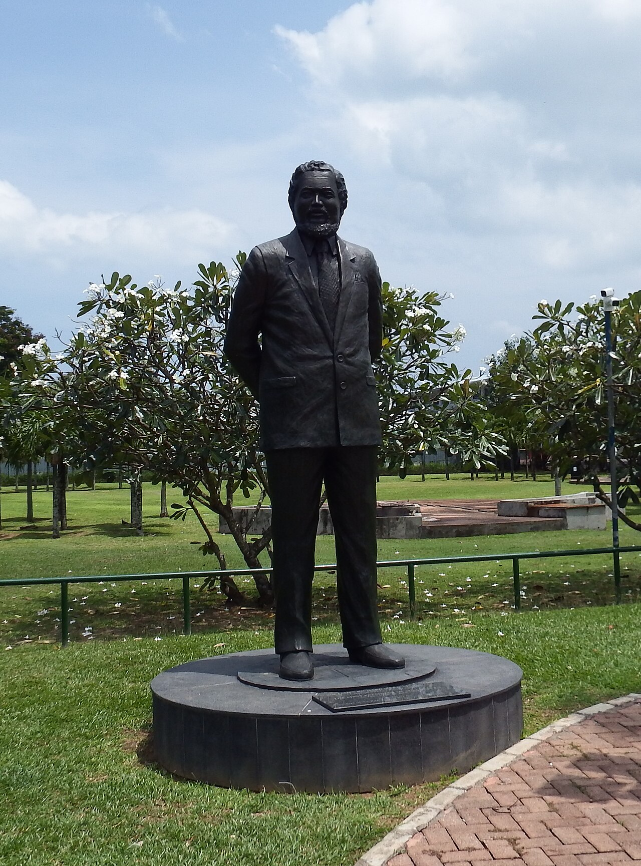 The bronze monument to Sir James Mancham, the first President of Seychelles, standing in a park in Victoria.