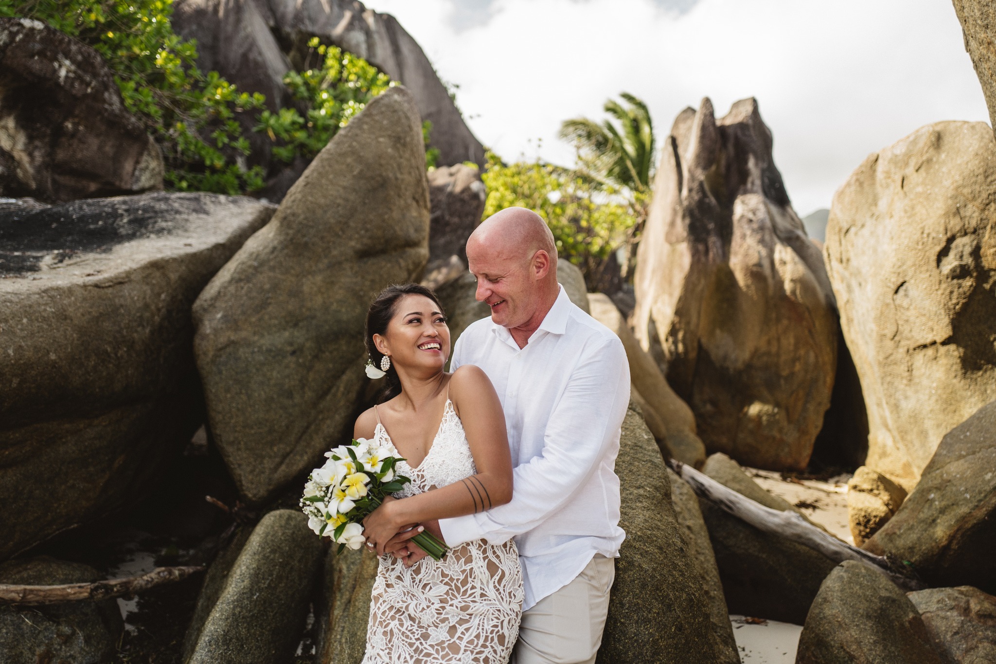 Bride and groom laughing together among huge sculpted granite boulders