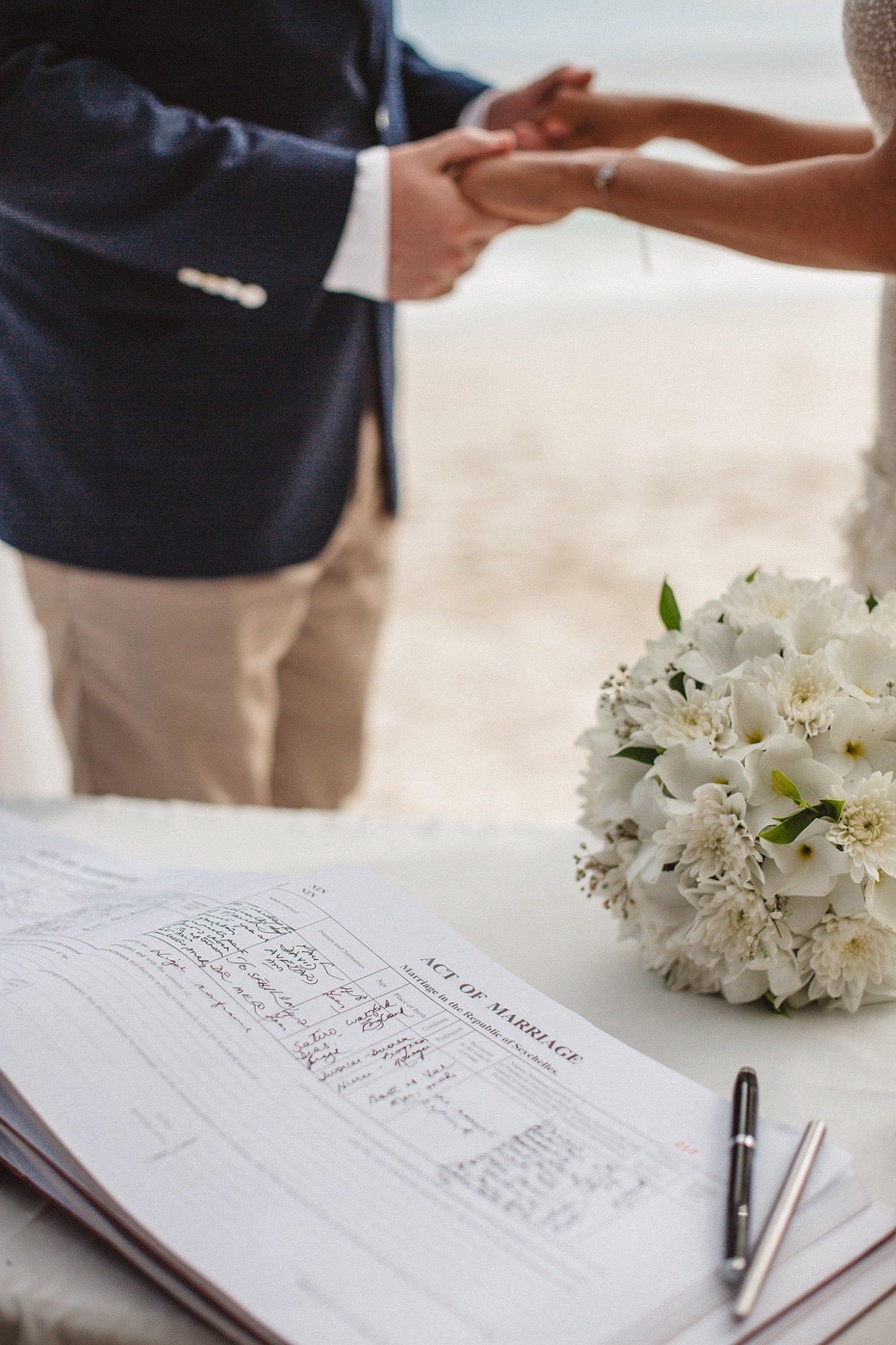 Signing the marriage register, a white bouquet on the table